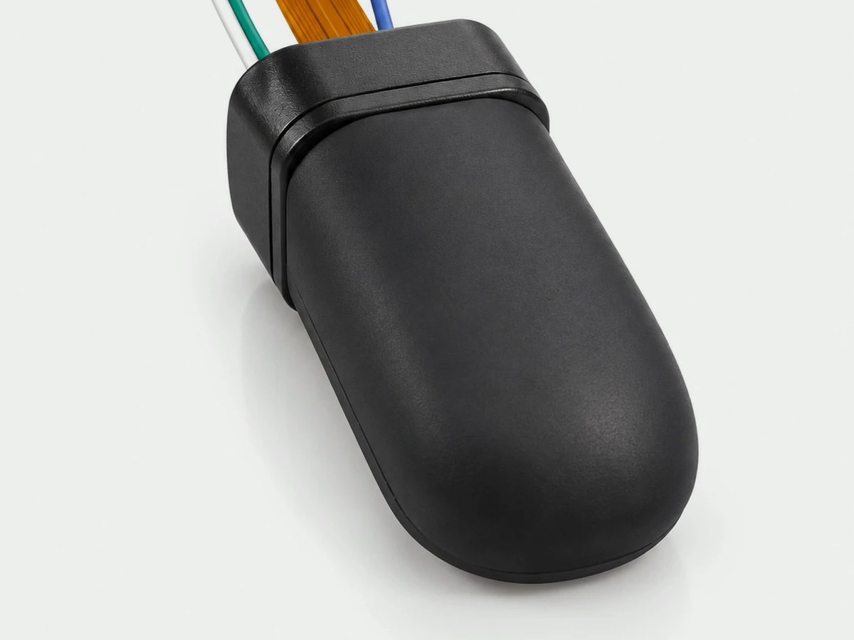 The fingertip GlowTact: a black rounded dome on a short housing with a flex cable
